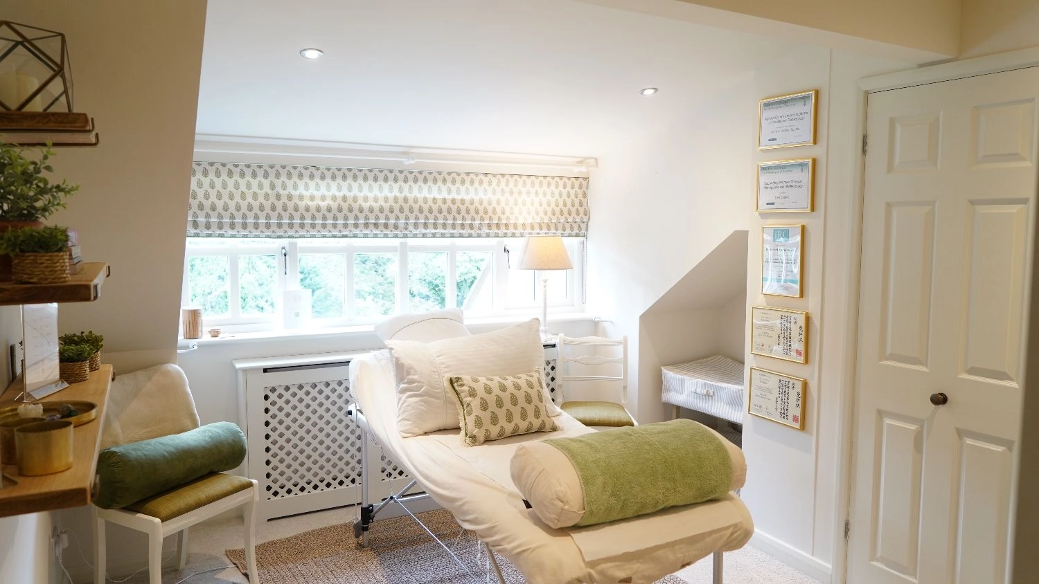 Rutland Reflexology treatment room with certifications on the walls, window, lamp, and treatment bed